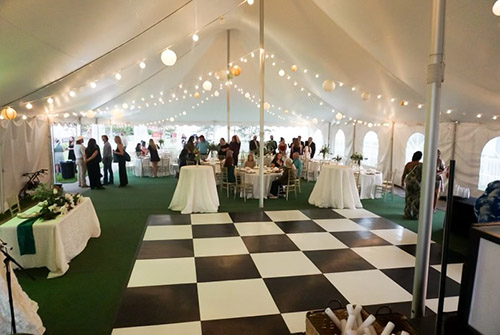 A photo of the inside of the Drish House's party tent with checkered dance floor.